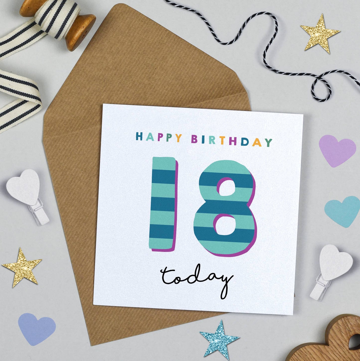 Birthday card with 'Happy Birthday 18 today' text on a white background with decorative items.