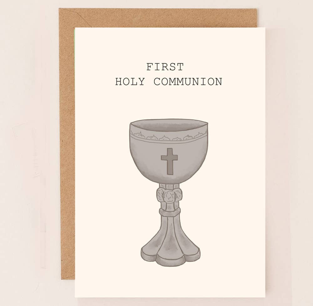 A simple card with the words First Holy Communion on it and a religious host goblet with kraft envelope.