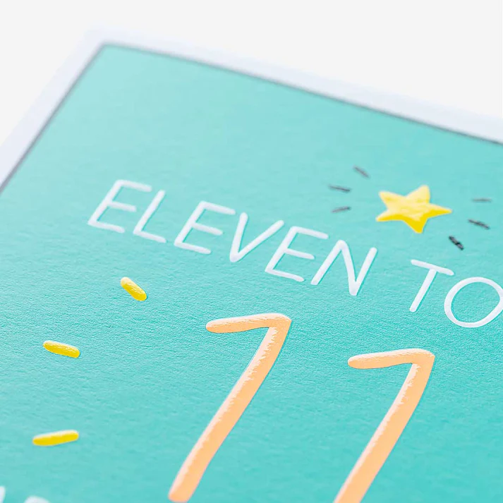 Teal card with 'Eleven to 77' text and yellow accents on a white background