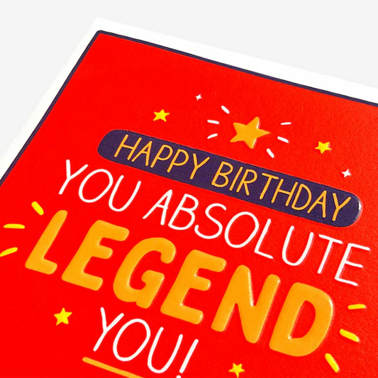 Red birthday card with yellow text saying 'Happy Birthday You Absolute Legend You!' on a white background