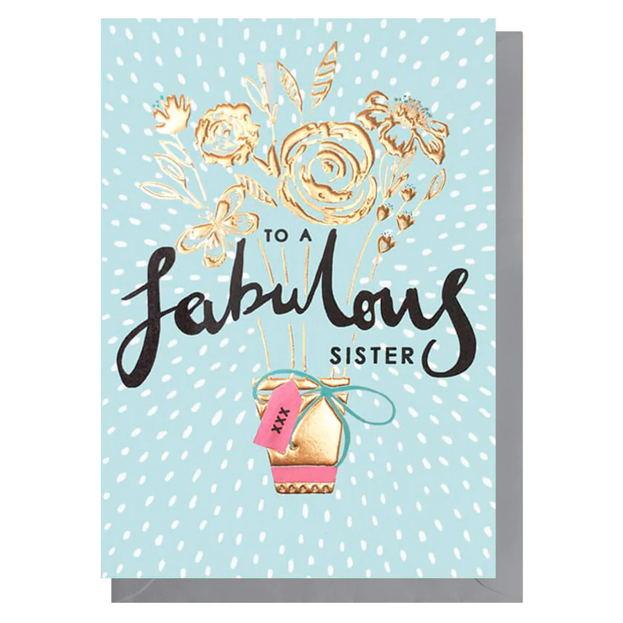 Greeting card with gold floral design and text 'To a fabulous sister' on a light blue background