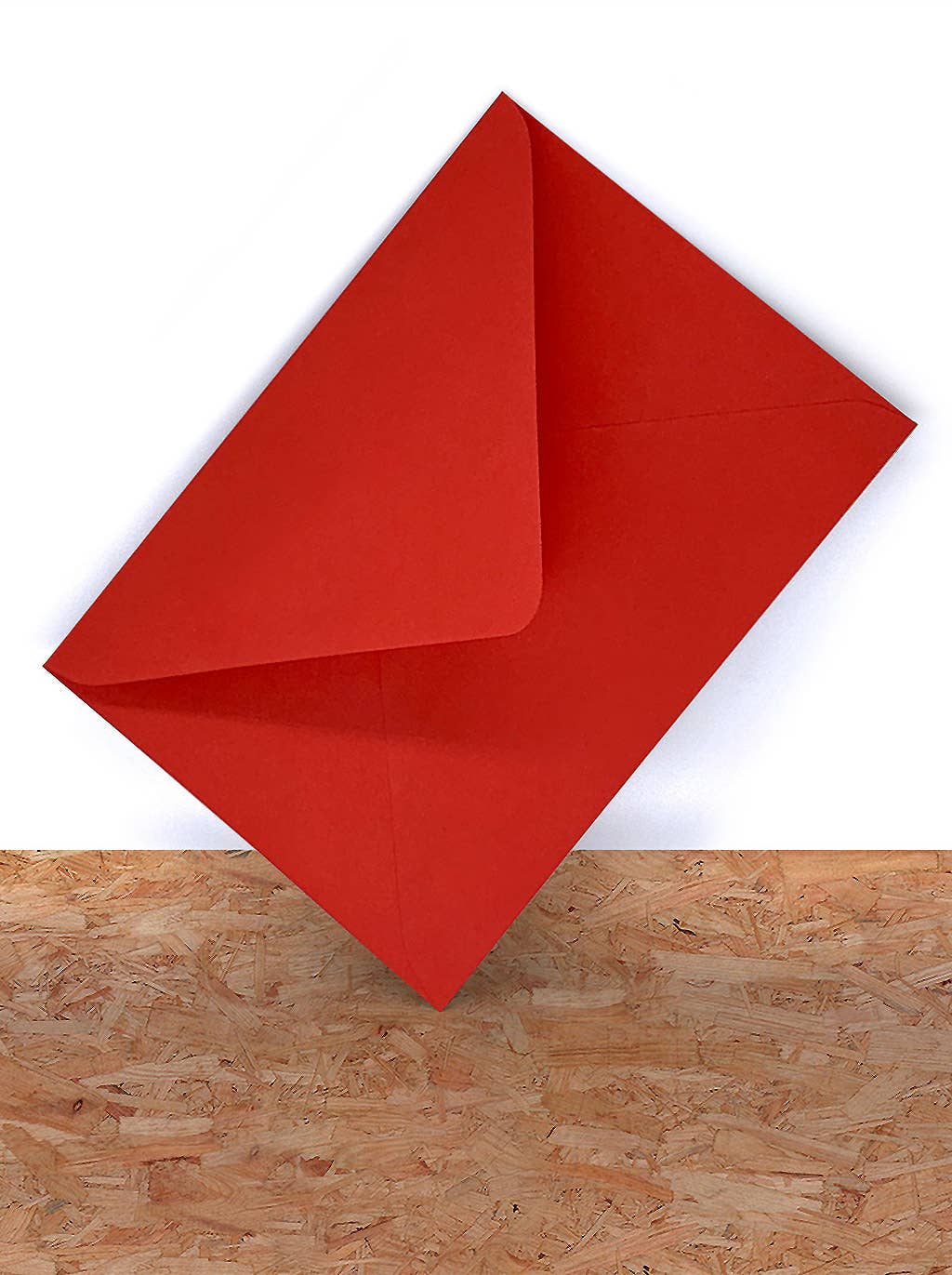 Red paper folded into a triangle on a wooden surface