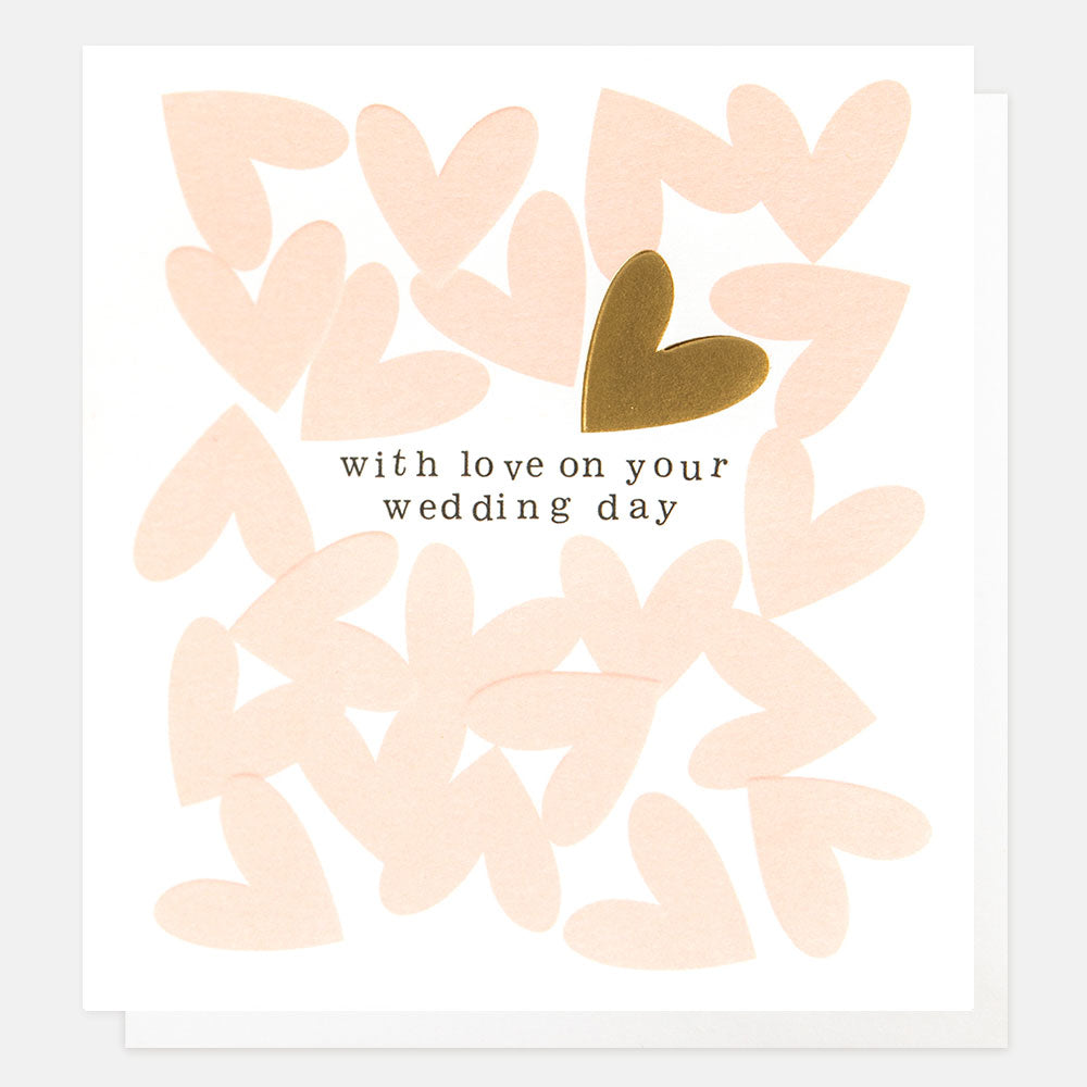A White card with pink hearts put on top randomly with the text 'with love on your wedding day' and a gold heart above it.