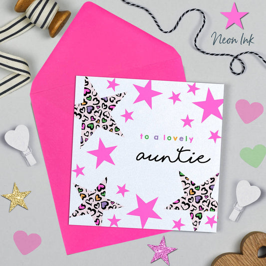 Greeting card for a lovely auntie with pink stars and hearts on a gray background.
