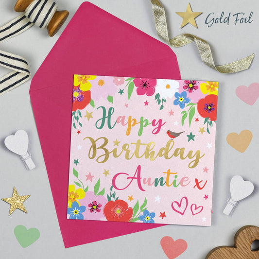 Birthday card for 'Auntie' with floral design and pink envelope on a decorative background.