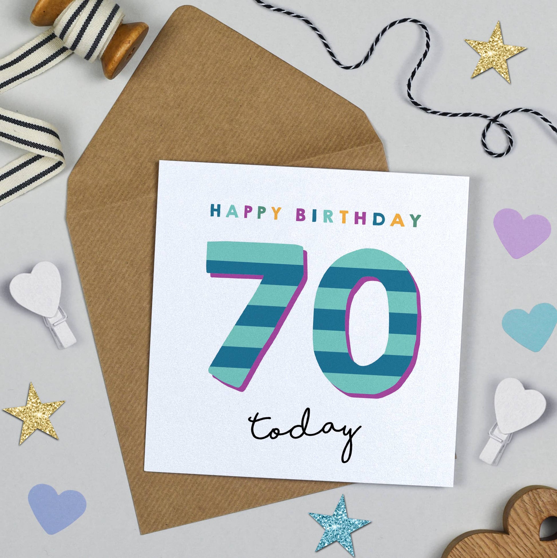 Birthday card with 'Happy Birthday 70 today' text on a decorative background with ribbons and stars.