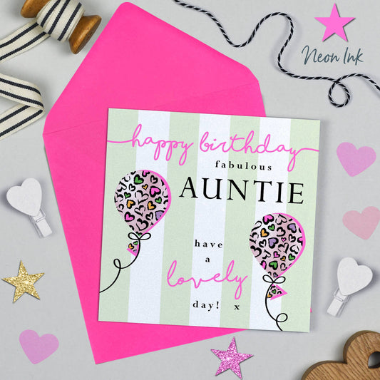 Birthday card for 'Auntie' with balloons and a pink envelope on a decorative background.