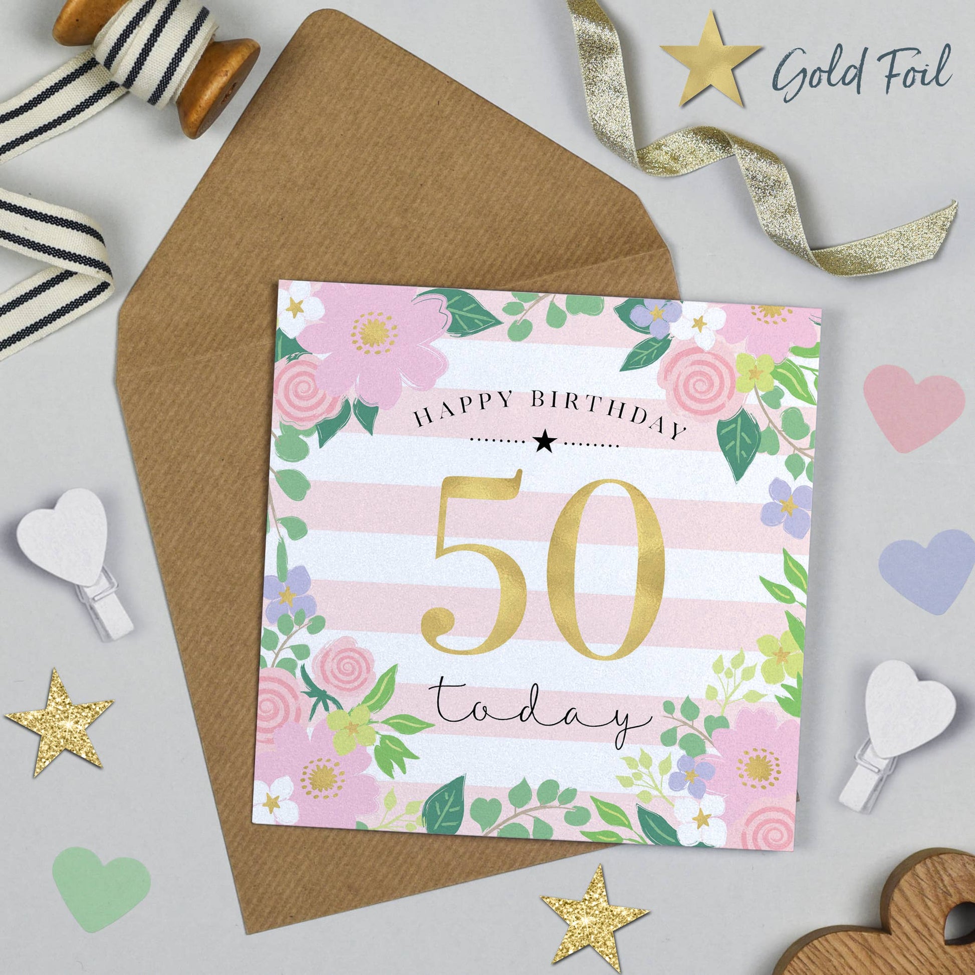 50th birthday card with floral design and gold foil text on a gray background