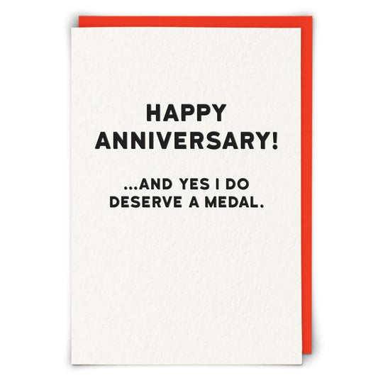 Greeting card with 'Happy Anniversary! ...and yes I do deserve a medal.' text on a white background with a red border.