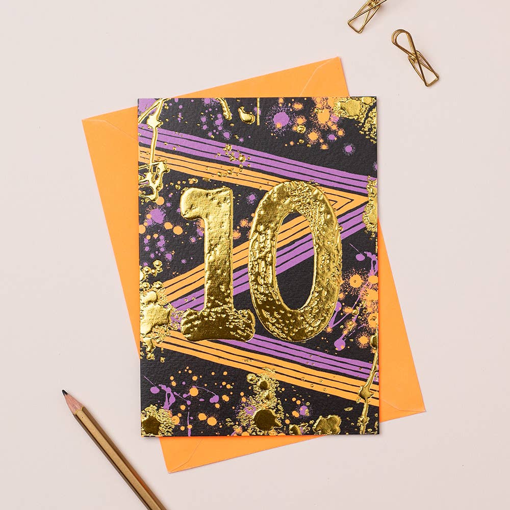 A card with a age 10 in the middle with paperclips and a pencil, and an orange envelope