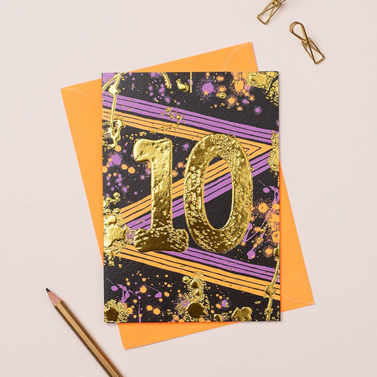 A card with a age 10 in the middle with paperclips and a pencil, and an orange envelope