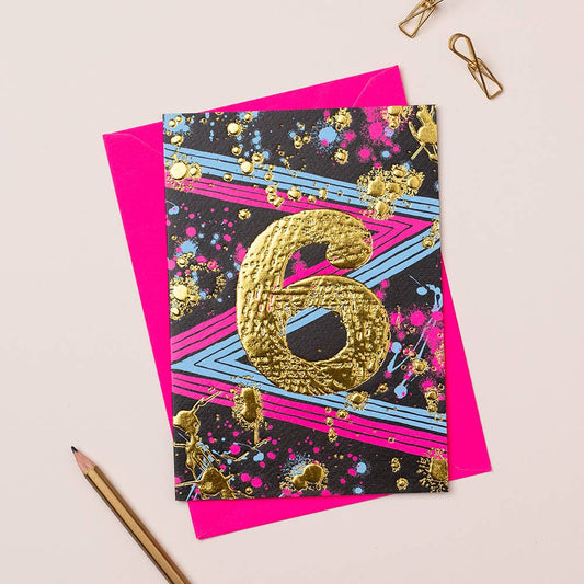 A colorful birthday card with number 6 design, gold foiling, and a pink envelope.