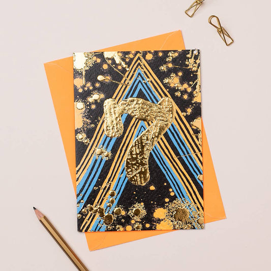An orange and blue card with an age 7 in gold foil in the middle