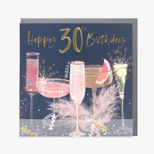 A greeting card with a 30th birthday theme, featuring images of champagne glasses, a cake, and decorations with gold foiling and embossing.