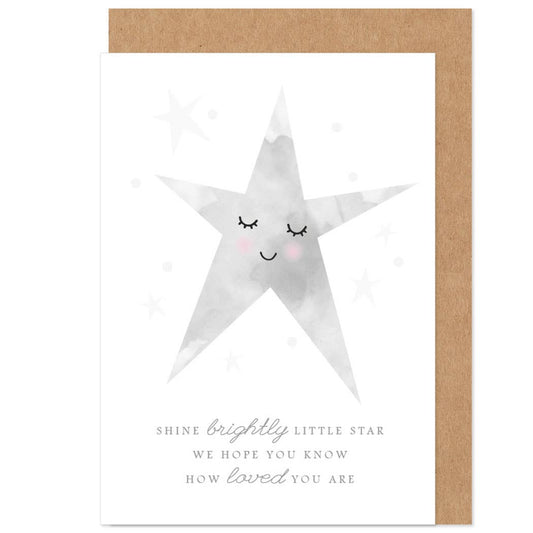 A greetings card with a white background featuring a stylized star with eyes and a smiling face, surrounded by smaller stars. The card has a brown kraft envelope and is blank inside for a personal message.