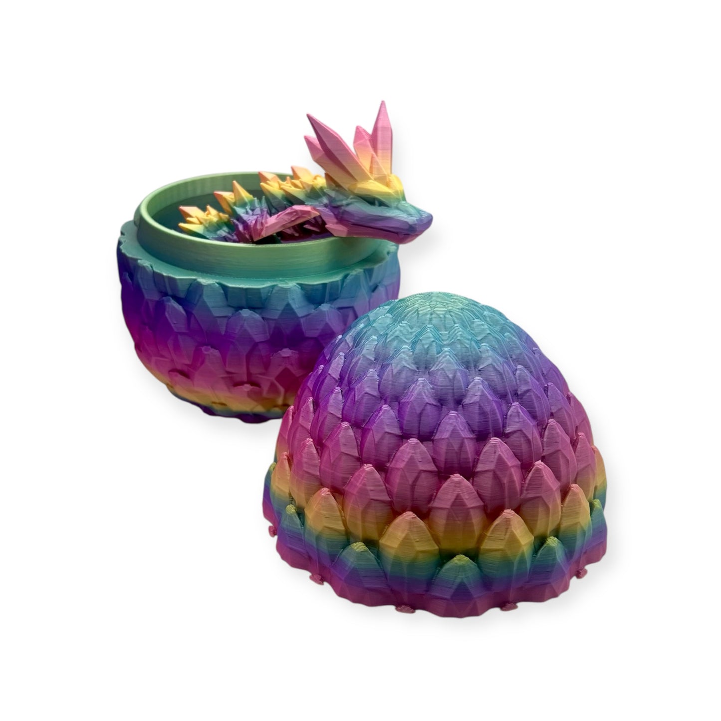 An image showing a 3D printed dragon egg with a dragon poking out against a white background.