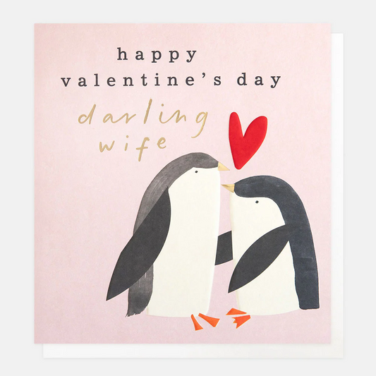 Valentine's Day card with penguins and a red heart on a pink background