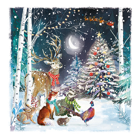 Winter scene with deer, fox, and birds near a decorated Christmas tree in a snowy forest.
