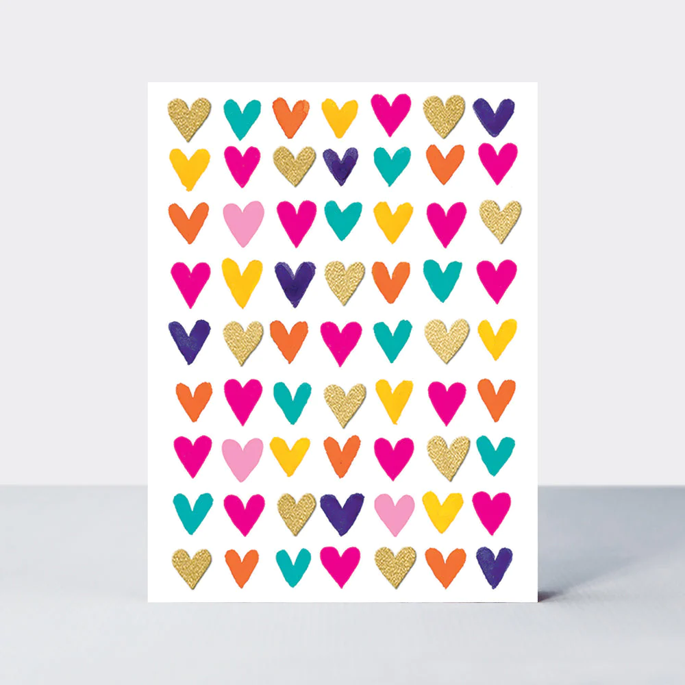 A white small card with many multi-coloured small hearts. No writing.