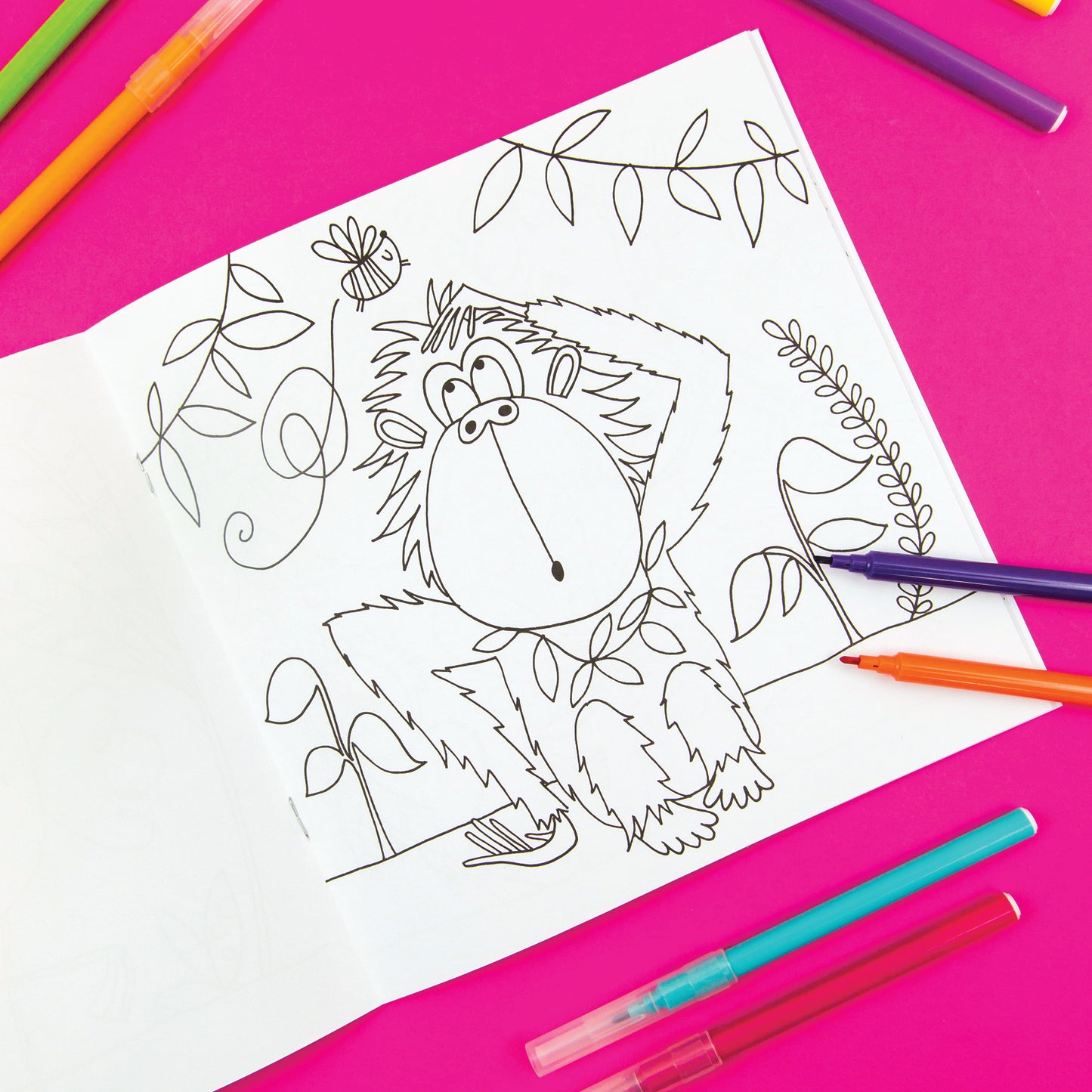 A white colouring book page with a hairy monkey and pens.