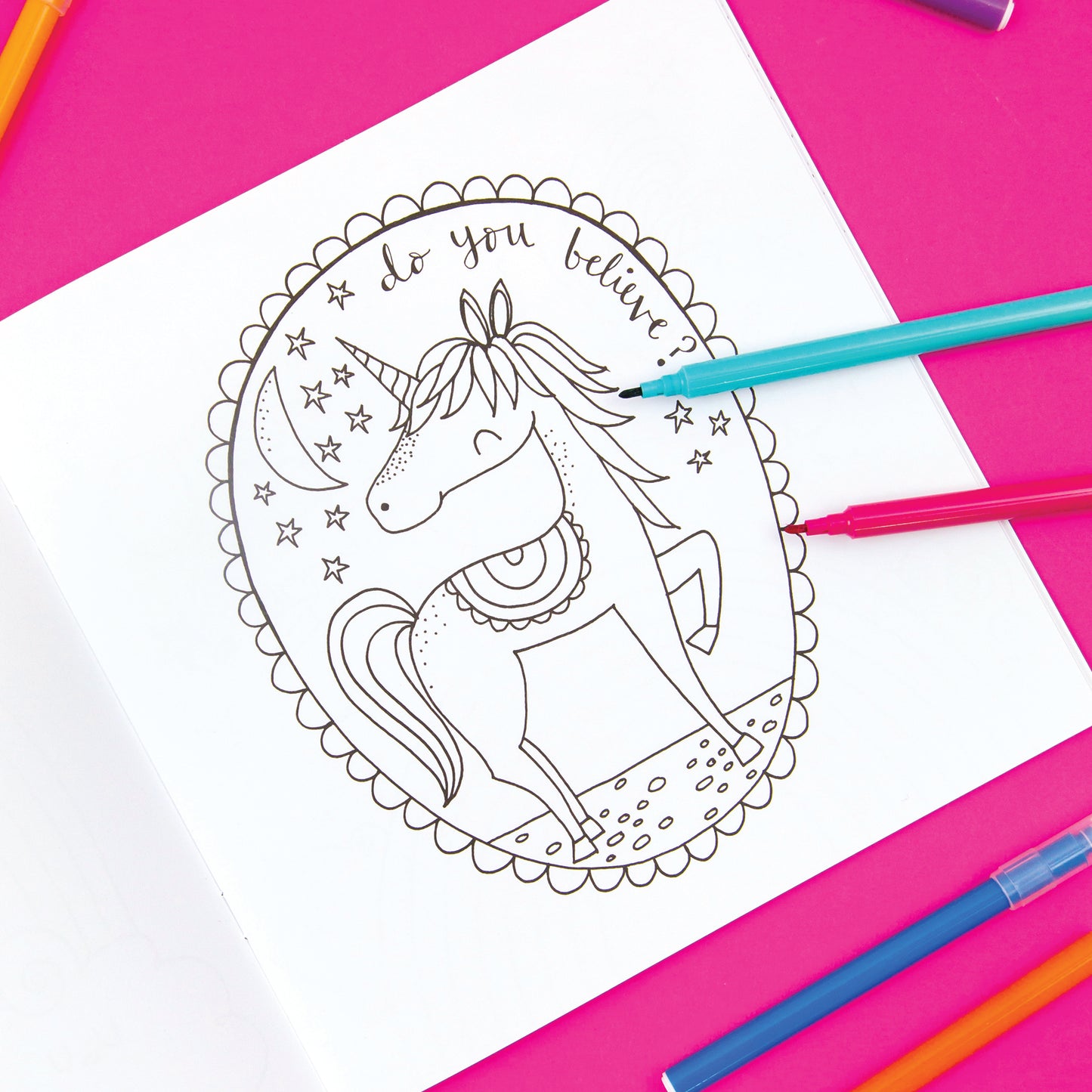 A white page with a unicorn for kids to colour in and then some felt tip pens.