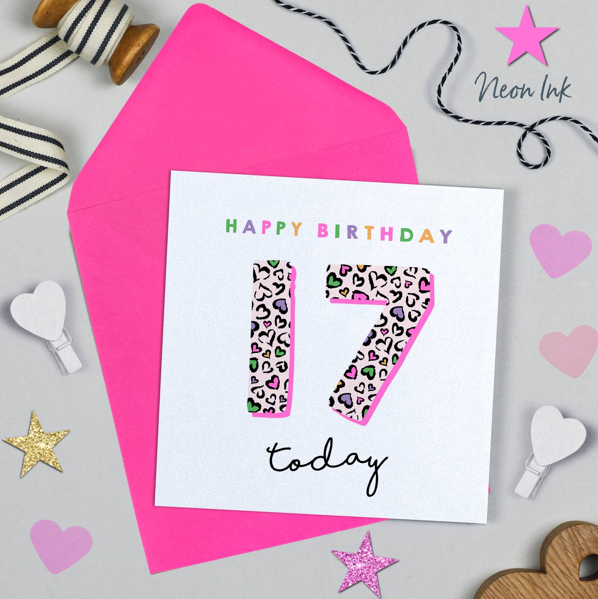 Birthday card with leopard print number 17 and 'Happy Birthday today' text, surrounded by decorative items on a light gray background.