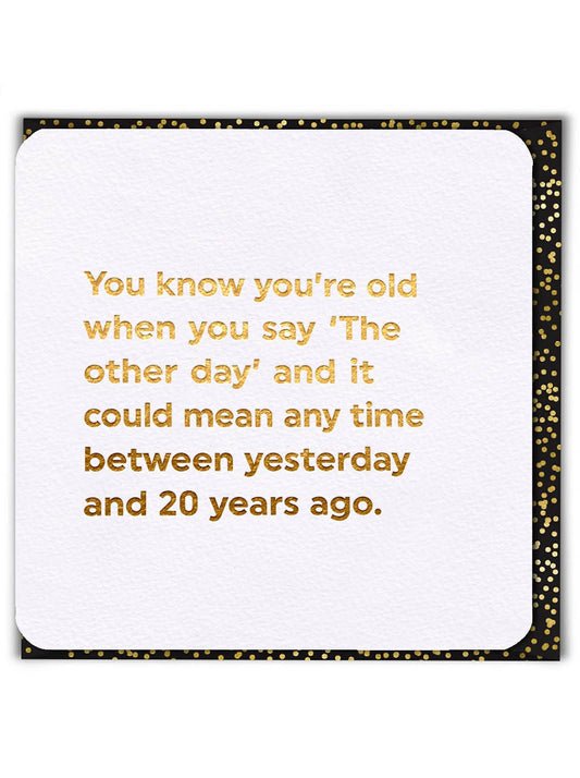 White card with gold text and black border