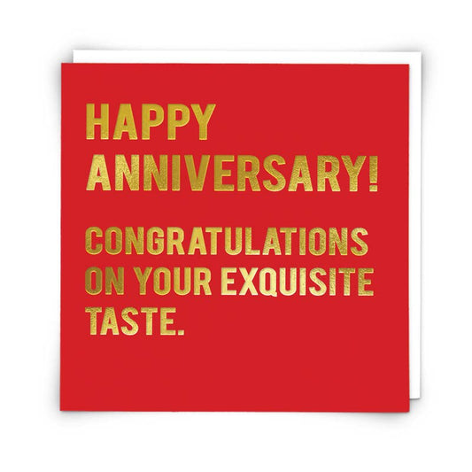 Red card with gold text saying 'Happy Anniversary! Congratulations on your exquisite taste.'