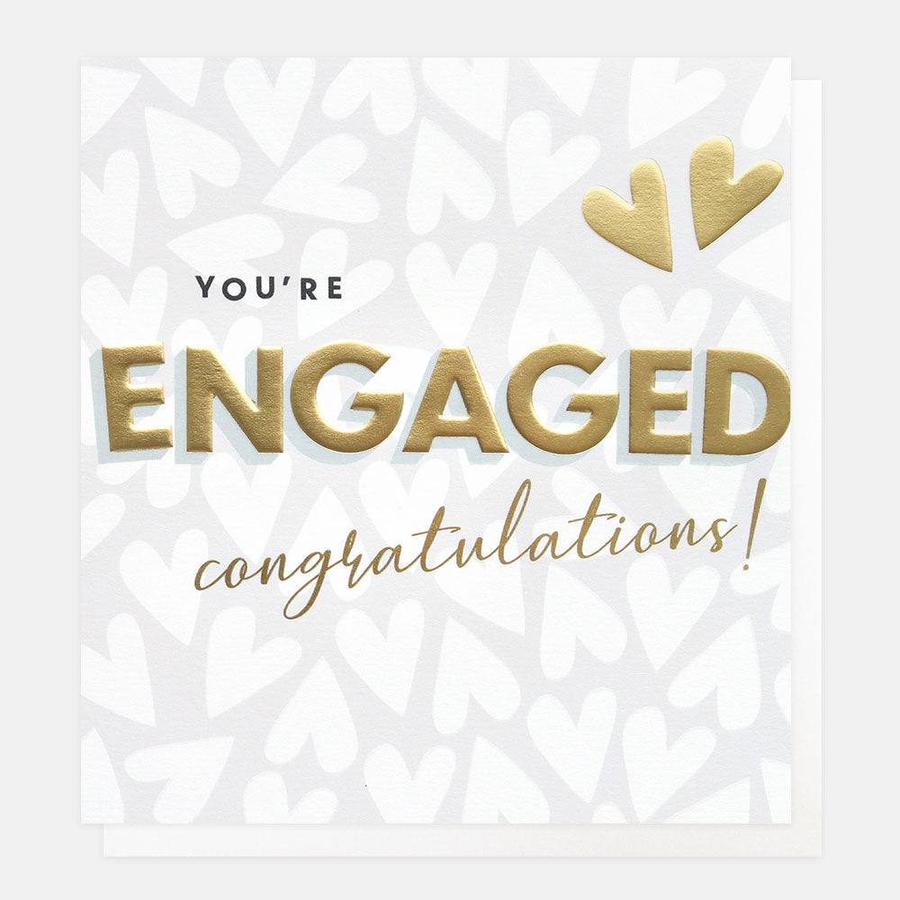 A silver card with white printed hearts in the background. The words You're Engaged Congratulations are shown in black and gold with two large gold hearts.