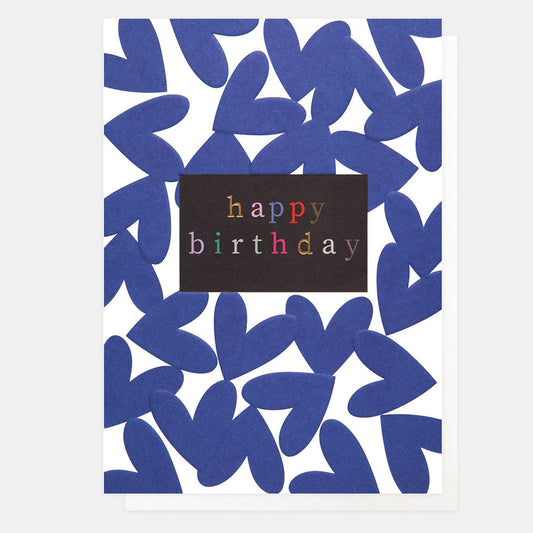 A white card with royal blue hearts on it and a black box with the words Happy Birthday