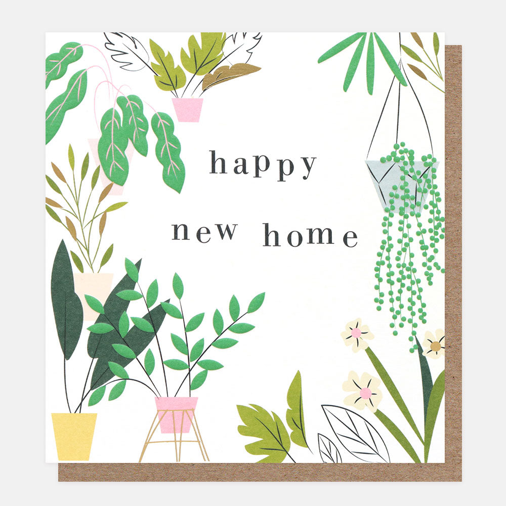 A white card with plants and flowers around the border with the words Happy New Home, written in black in the centre. A brown Kraft envelope is also shown.