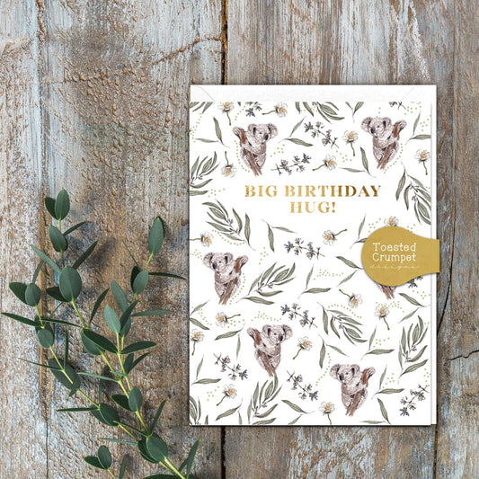 A white card with koalas and leaves with the words Big Birthday Hug