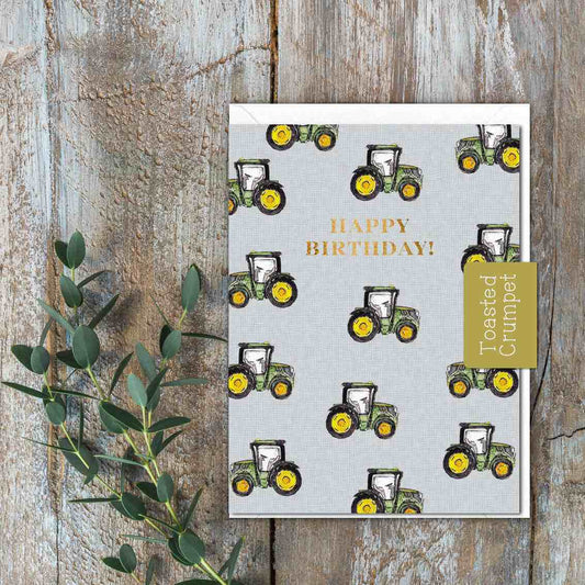 A small Grey/blue card with green tractors and the words Happy Birthday