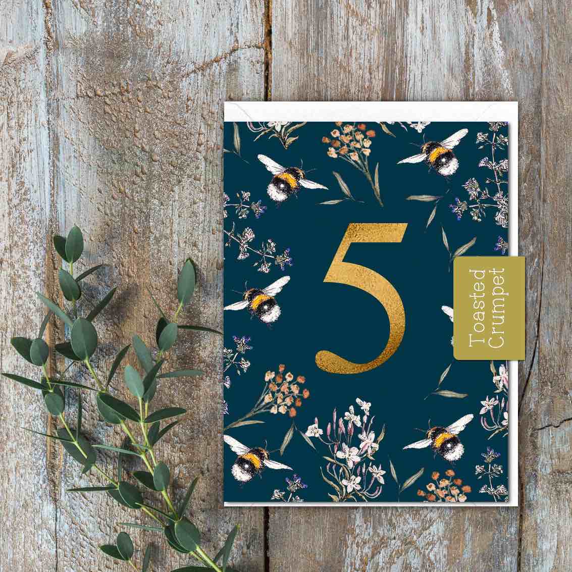 A deep blue card with Bees and flowers and a large gold 5 in the middle.